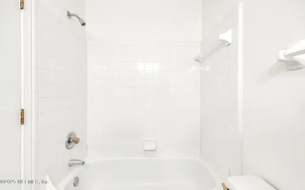 a bathroom with a shower and a toilet