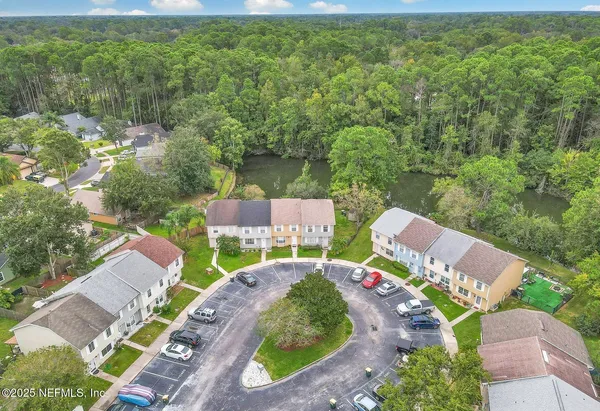 an aerial view of a house with garden space and street view