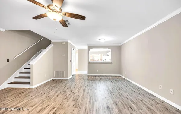 wooden floor in an empty room with a window