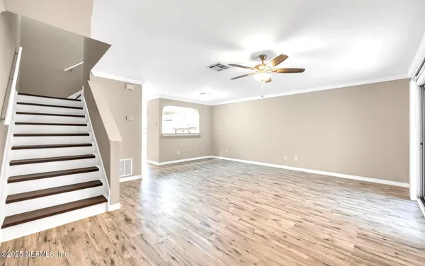 wooden floor in an empty room with a window