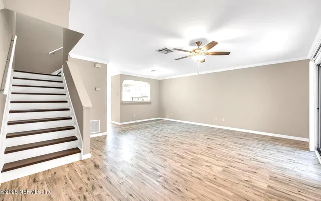 wooden floor in an empty room with a window