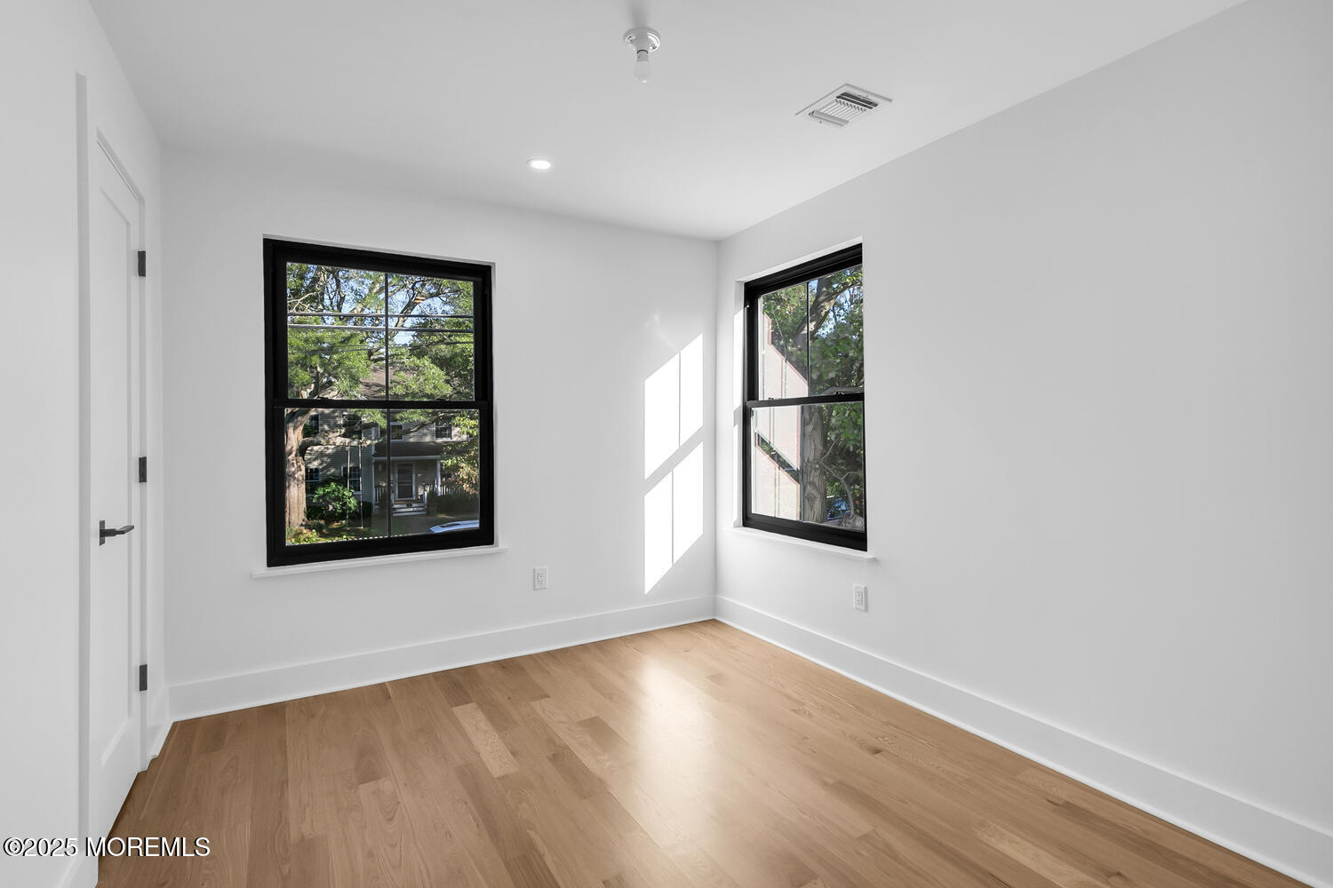 514 River Road Fair Haven, NJ 07704 - Photo 38 of 62 an empty room with wooden floor and windows