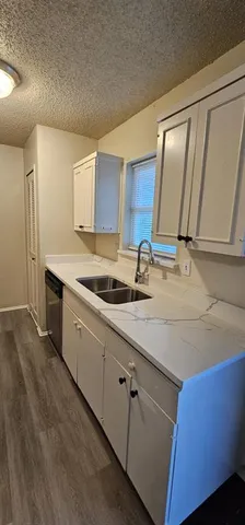 a kitchen with sink and mirror