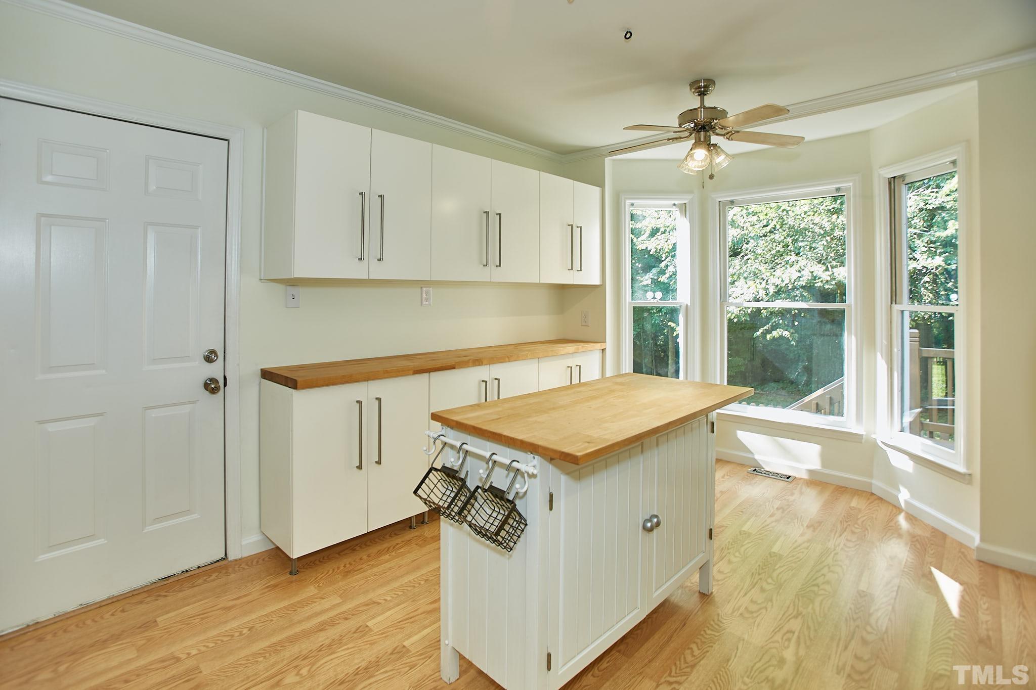 4616 Knightsbridge Way Raleigh, NC 27604 - Photo 16 of 27 a kitchen with a stove a sink a window and a refrigerator
