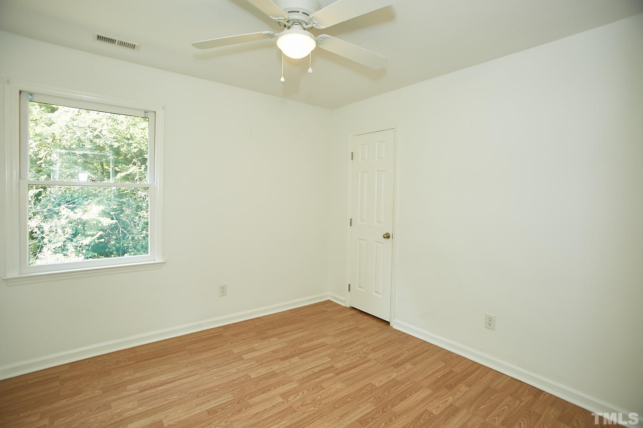 4616 Knightsbridge Way Raleigh, NC 27604 - Photo 23 of 27 an empty room with a window and a fan