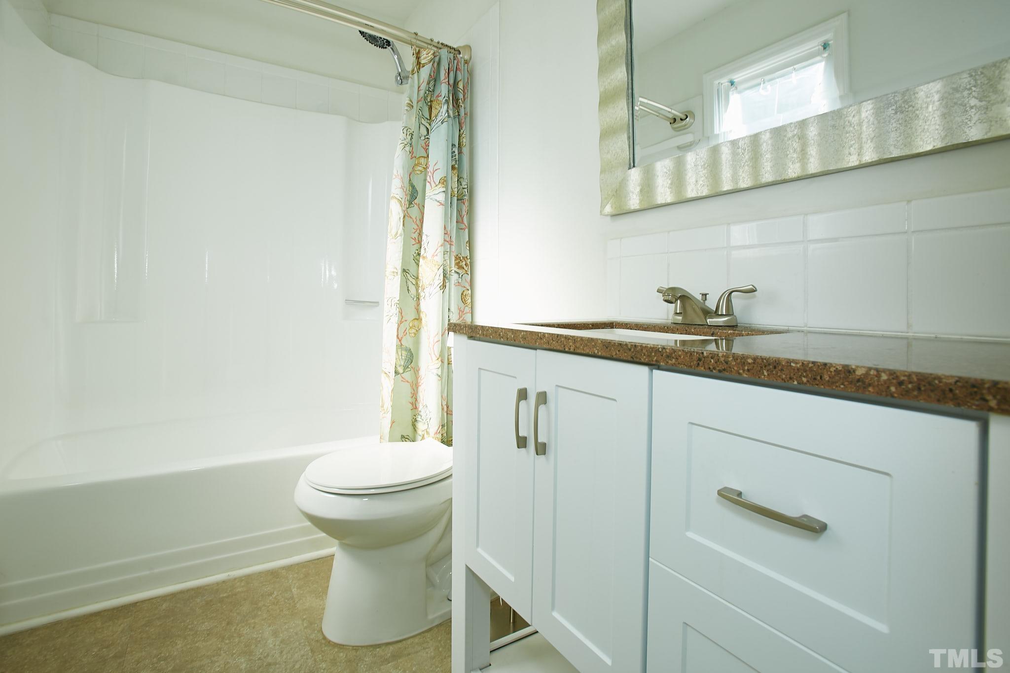 4616 Knightsbridge Way Raleigh, NC 27604 - Photo 24 of 27 a bathroom with a sink and a toilet