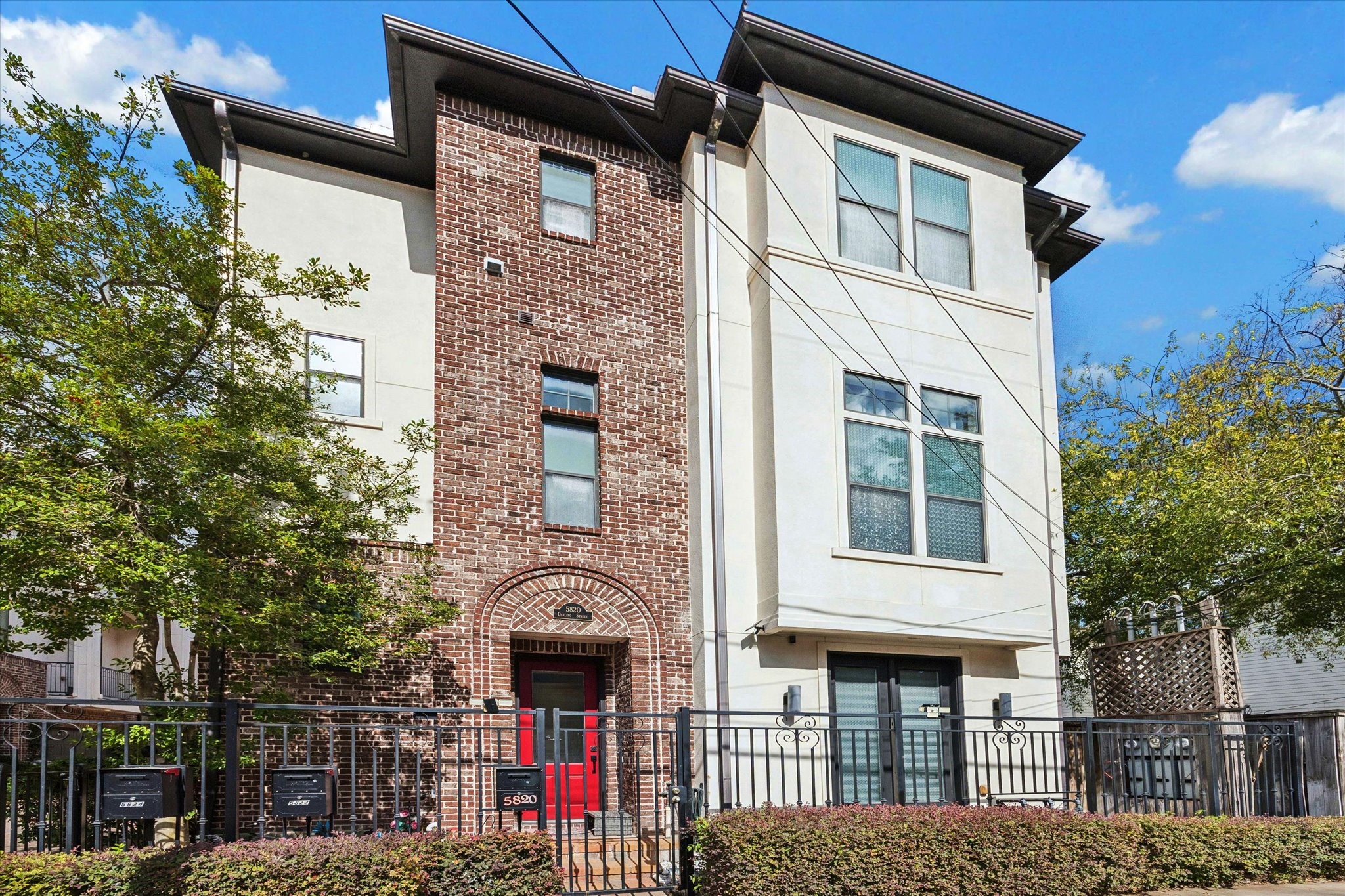 a front view of a residential apartment building with a yard