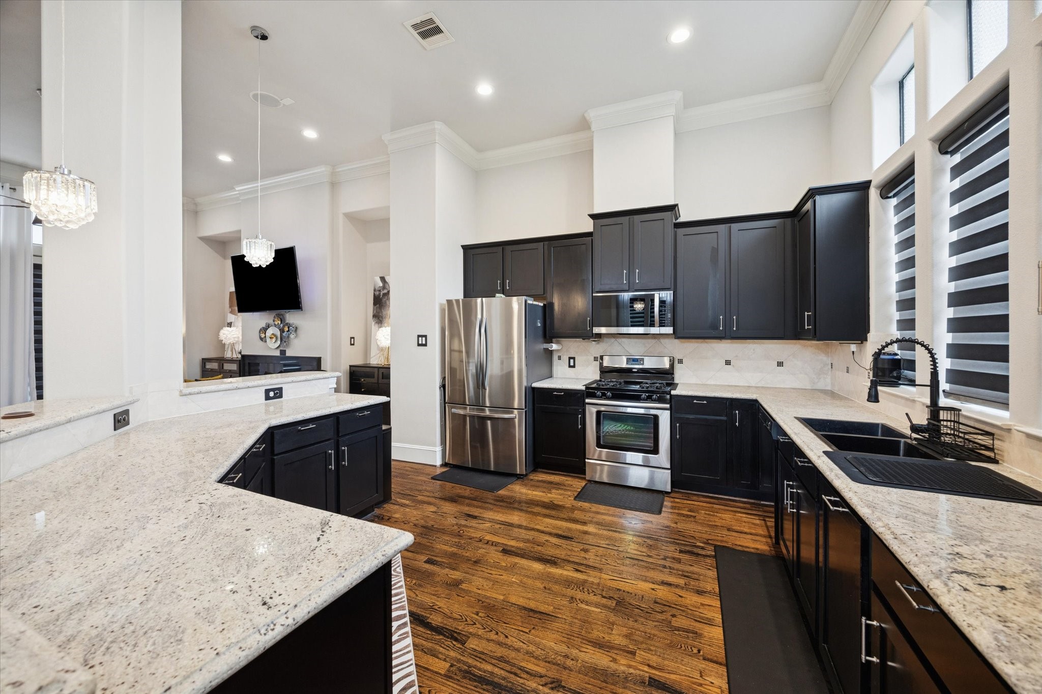 5820 Darling Street Houston, TX 77007 - Photo 4 of 24 a kitchen with stainless steel appliances wooden cabinets granite counter tops a stove a sink and a refrigerator