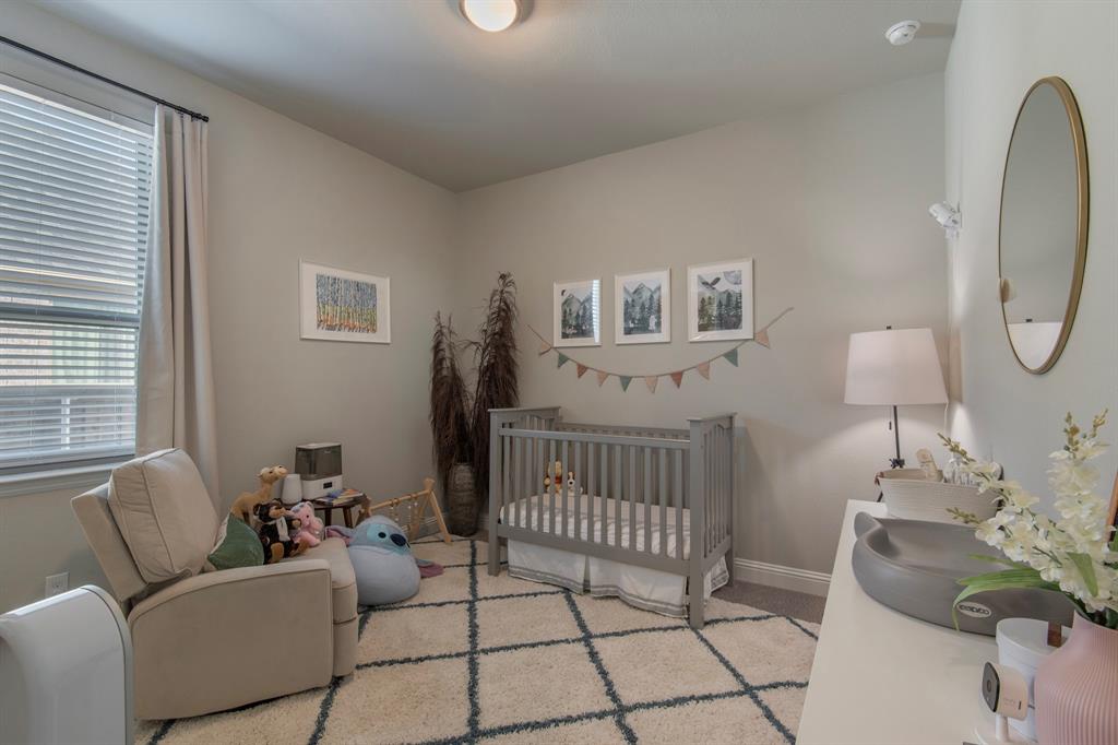16650 Nightshade Road Frisco, TX 75033 - Photo 24 of 40 a bedroom with furniture and a window