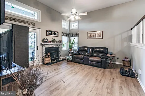 a living room with furniture a fireplace and a flat screen tv