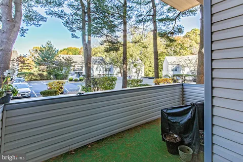 a view of a porch with furniture and garden