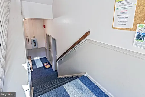 a view of entryway with wooden floor and stairs
