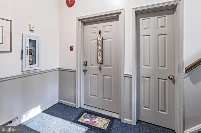 wooden floor with white walls and windows