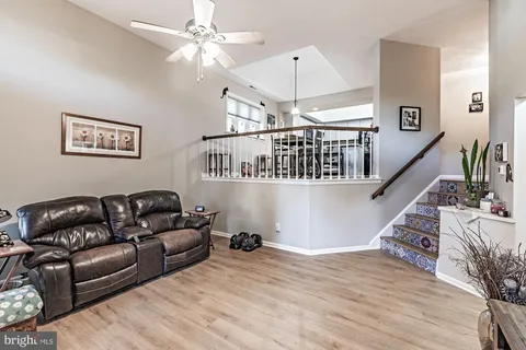 a living room with furniture and a chandelier