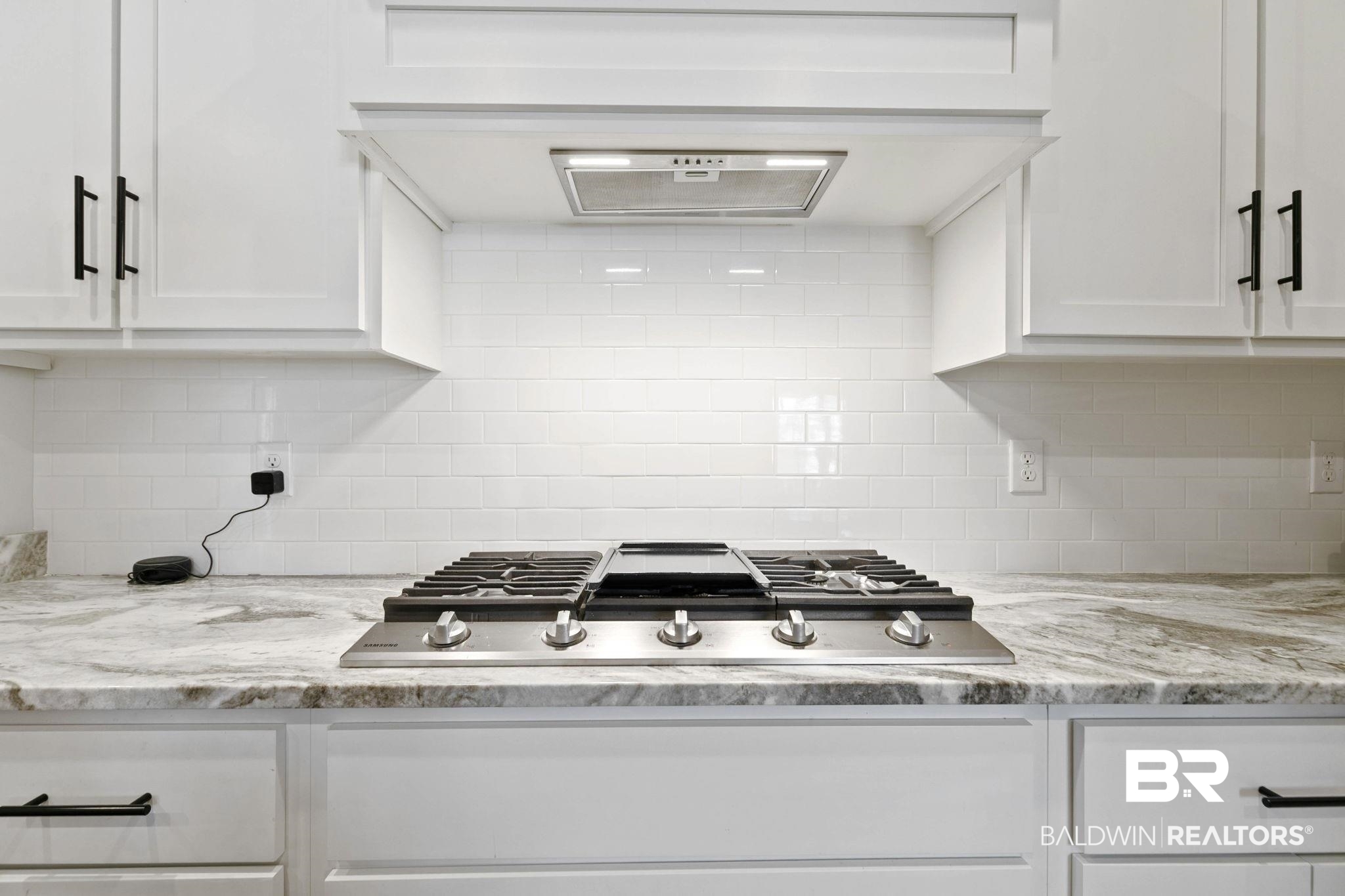 291 Hemlock Drive Fairhope, AL 36532 - Photo 19 of 65 Kitchen featuring exhaust hood, white cabinets, stainless steel gas stovetop, and light stone countertops
