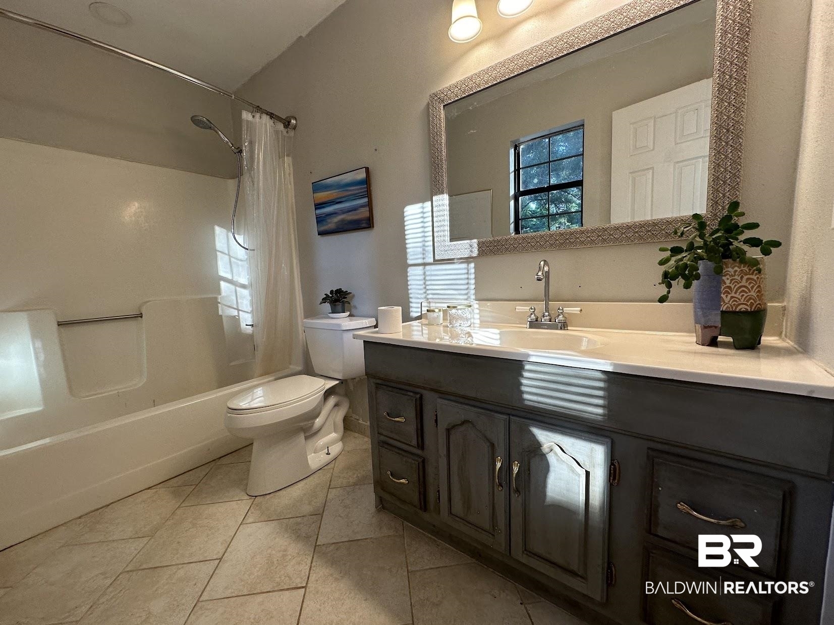 8450 Murray Road Irvington, AL 36544 - Photo 12 of 20 Full bathroom featuring tile patterned floors, toilet, shower / tub combo with curtain, and vanity