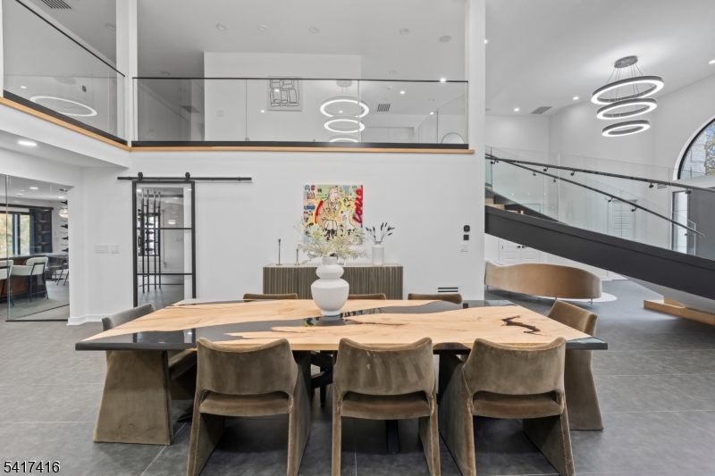 84 County Rte 635 Livingston, NJ 07039 - Photo 11 of 30 a dining area with a table chairs and a kitchen view