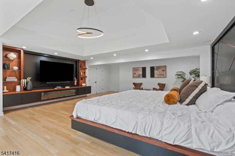 84 County Rte 635 Livingston, NJ 07039 - Photo 15 of 30 a bedroom with a bed and a flat screen tv