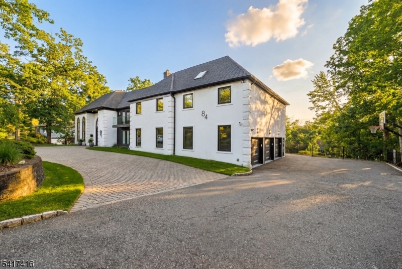 84 County Rte 635 Livingston, NJ 07039 - Photo 2 of 30 a view of a white house with a yard and large tree