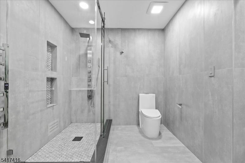 84 County Rte 635 Livingston, NJ 07039 - Photo 22 of 30 a bathroom with a shower and toilet