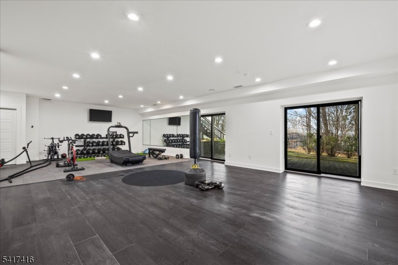 84 County Rte 635 Livingston, NJ 07039 - Photo 25 of 30 a view of a room with gym equipment and a floor to ceiling window
