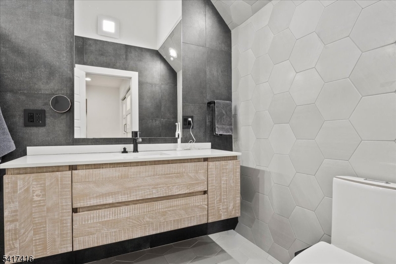 84 County Rte 635 Livingston, NJ 07039 - Photo 28 of 30 a bathroom with a double vanity sink and a mirror