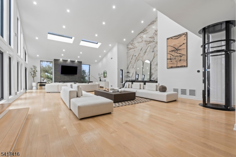 84 County Rte 635 Livingston, NJ 07039 - Photo 6 of 30 a living room with furniture and a flat screen tv