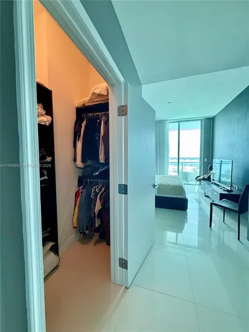 a view of a livingroom with furniture and a gym