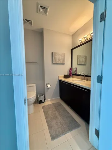 a en suite bathroom with a sink a toilet and mirror