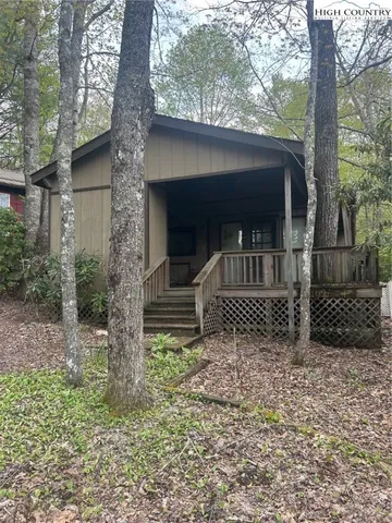 a view of a house with a tree in the yard