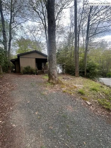 a view of a house with a tree and a yard