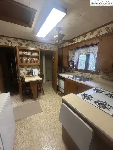 a living room with stainless steel appliances kitchen island granite countertop furniture and a fireplace