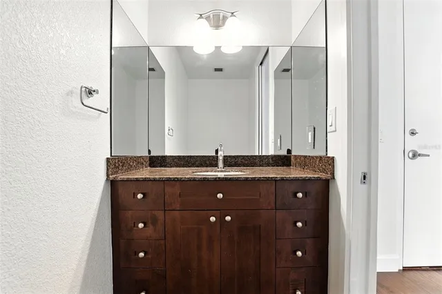 a view of a livingroom with a ceiling fan & entryway