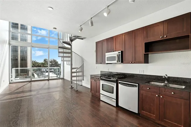 a kitchen with stainless steel appliances a stove a sink and a refrigerator