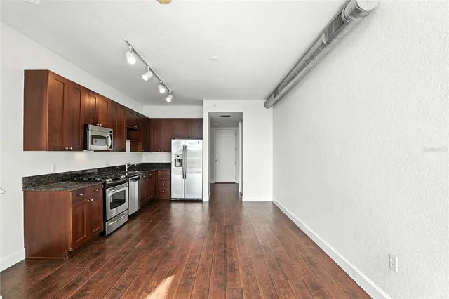 a view of staircase with railing and white walls