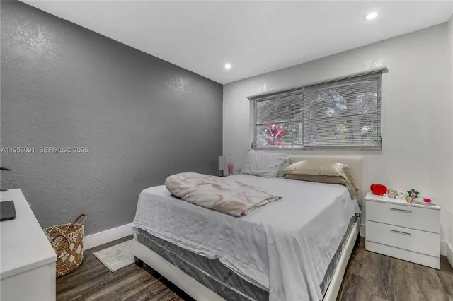 a bed room with a bed and a potted plant