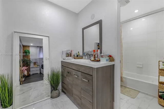 a white toilet sitting next to a bath tub