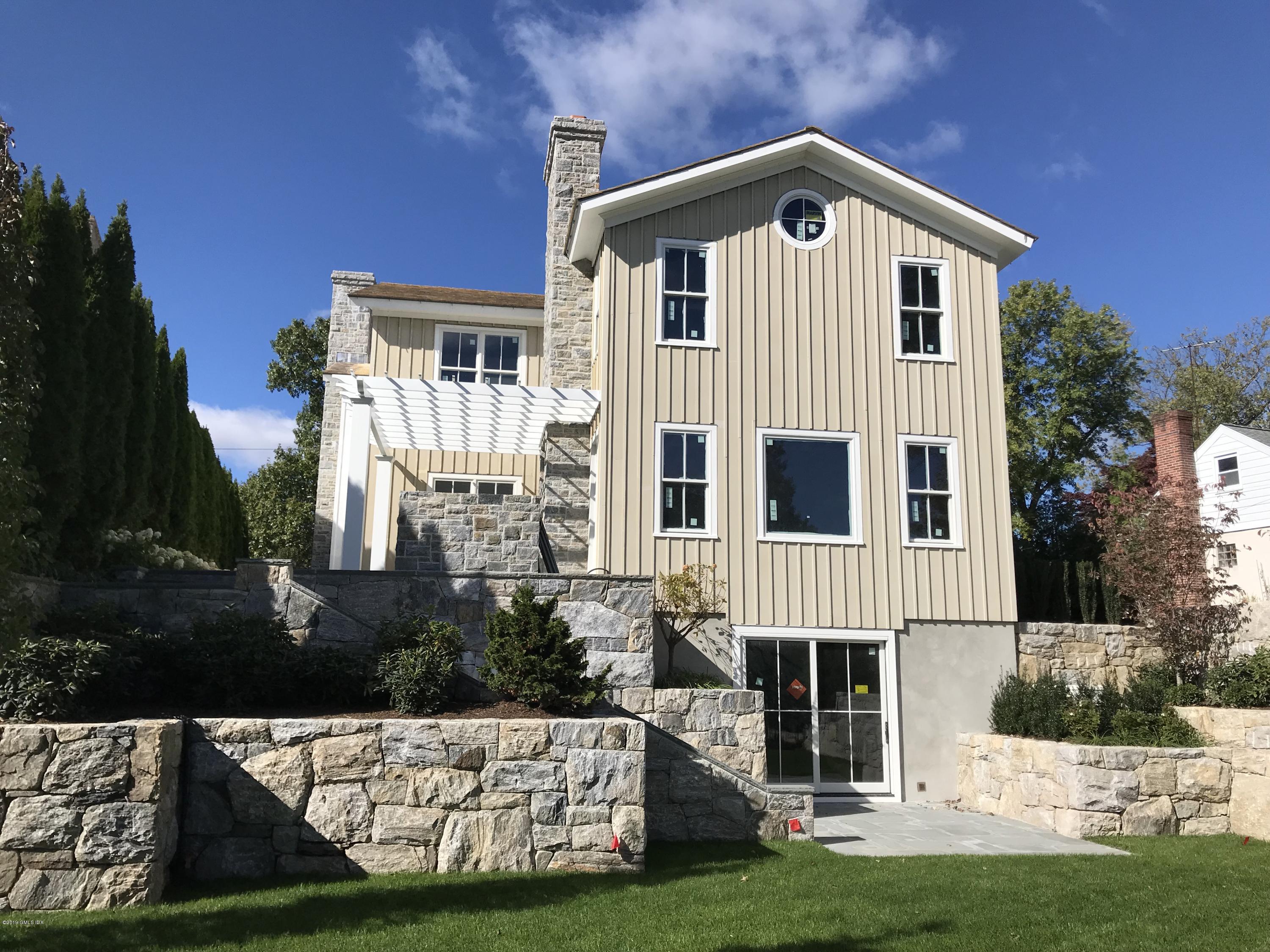 53 Sheep Hill Road Riverside, CT 06878 - Photo 2 of 10 a front view of a house with garden