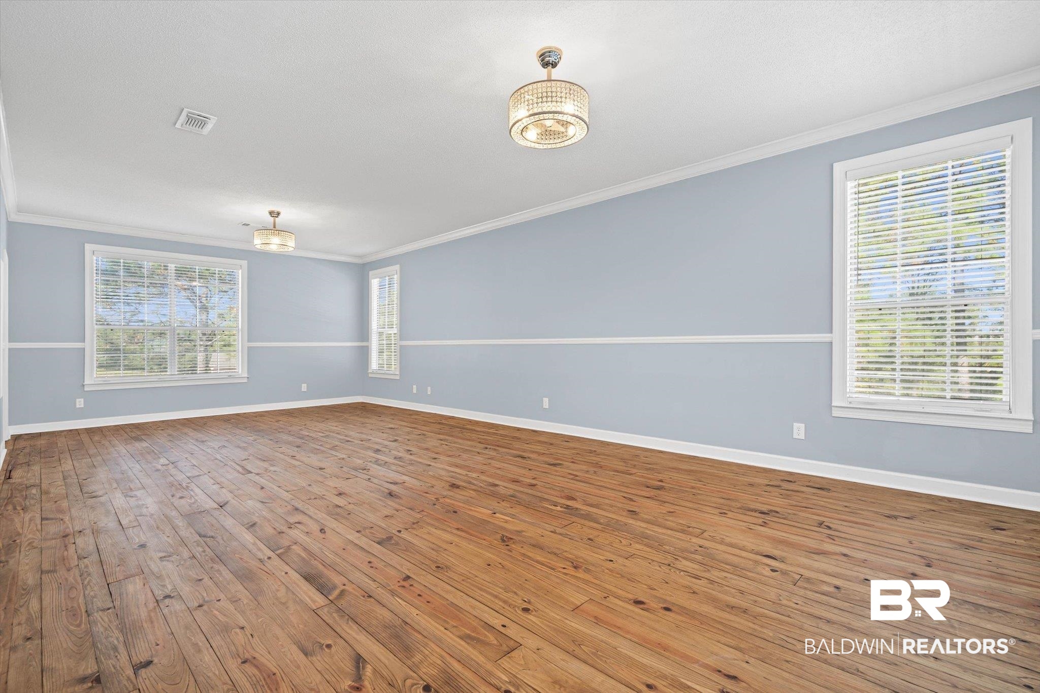 7650 Iron Rush Road Wilmer, AL 36587 - Photo 18 of 34 Unfurnished room with ornamental molding and wood-type flooring