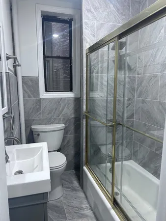 a bathroom with a toilet and a bathtub