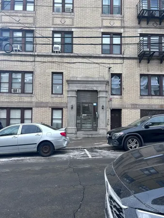a front view of a building with parking space