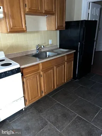 a kitchen with stainless steel appliances a sink stove and cabinets
