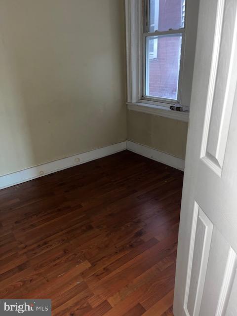 5634 Walnut Street Philadelphia, PA 19139 - Photo 6 of 13 a view of an empty room with wooden floor and a window