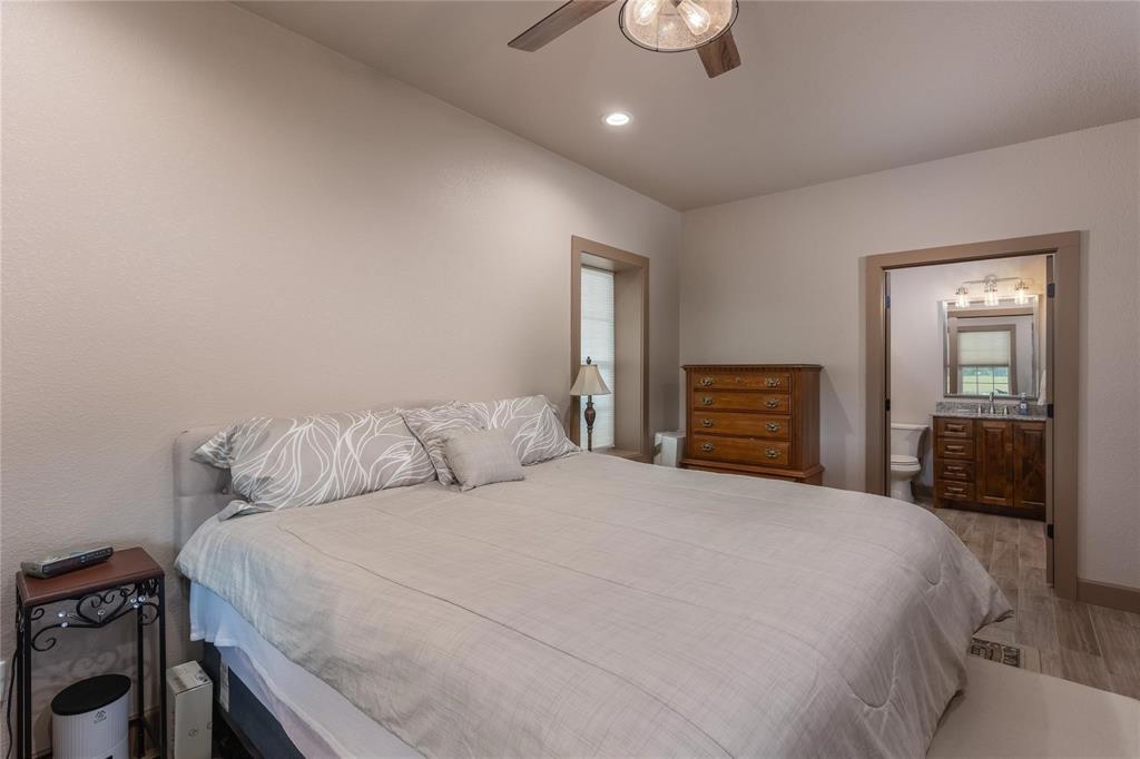 210 Spring Branch Trail North Springtown, TX 76082 - Photo 14 of 36 Bright bedroom with neutral wall tones and recessed lighting