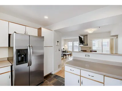 a kitchen with stainless steel appliances a refrigerator and a stove top oven