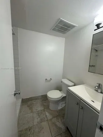 a bathroom with a sink toilet and vanity