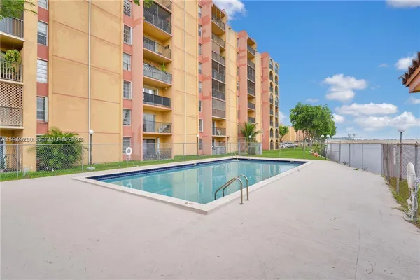 a view of pool with a yard