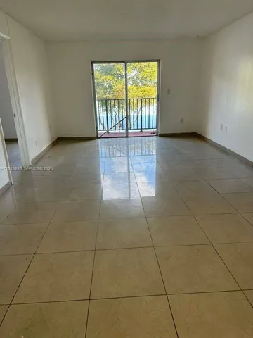 a bathroom with a white toilet and bathtub