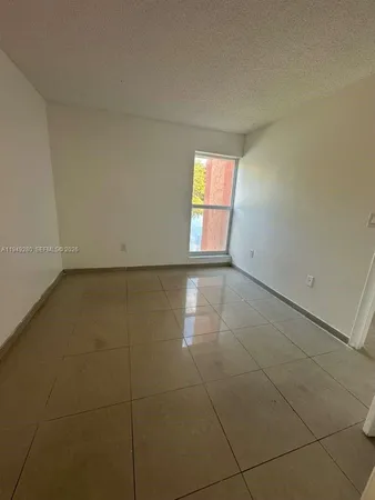 a view of an empty room and a window