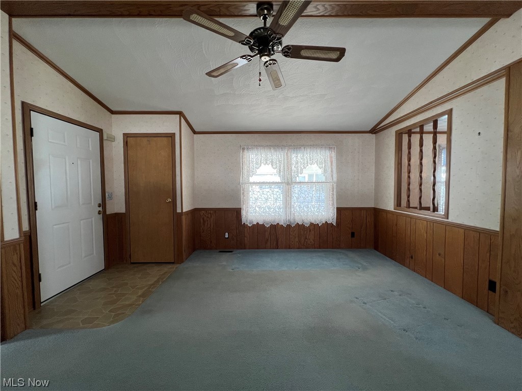 12921 Springfield Road, Unit 3N New Springfield, OH 44443 - Photo 3 of 19 Unfurnished entrance room featuring lofted ceiling, crown molding, carpet floors, and ceiling fan